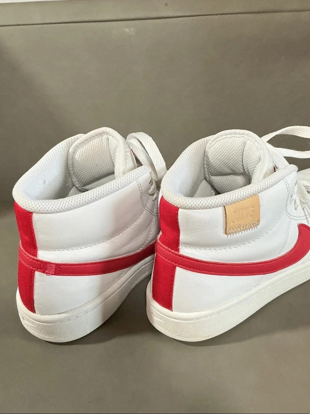 Nike Women's White Sneakers with Pink Swoosh High-Top